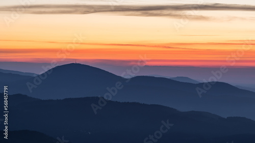 Mountain layers with a dramatic sky before sunrise