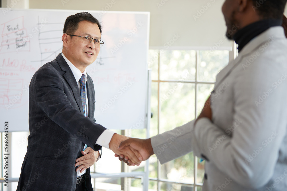 businessman shaking hands from success at work or project in the office businessman shaking hands from success at work or project in the office
