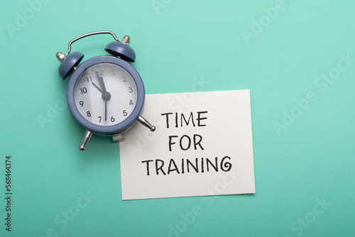 Phrase Time for Training and alarm clock on cyan background