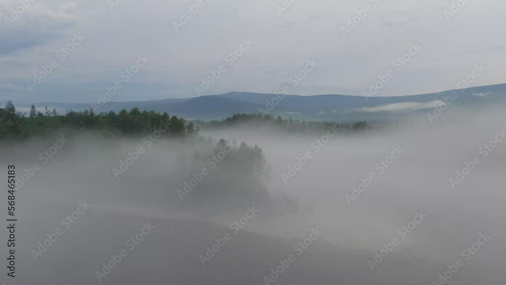 Misty early winter morning at lake where water evaporates creating dangerous fog Misty early winter morning at lake where water evaporates creating dangerous fog