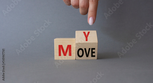 My Move symbol. Businessman hand points at turned wooden cubes with words My Move. Beautiful grey background. Business and My Move concept. Copy space