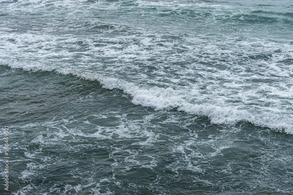 Storm sea. Waves on the sea dispersed by the wind on a cloudy day.