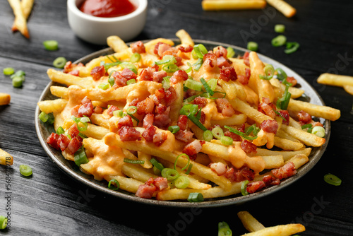 Crispy French fries loaded with bacon, cheese sauce and spring onion