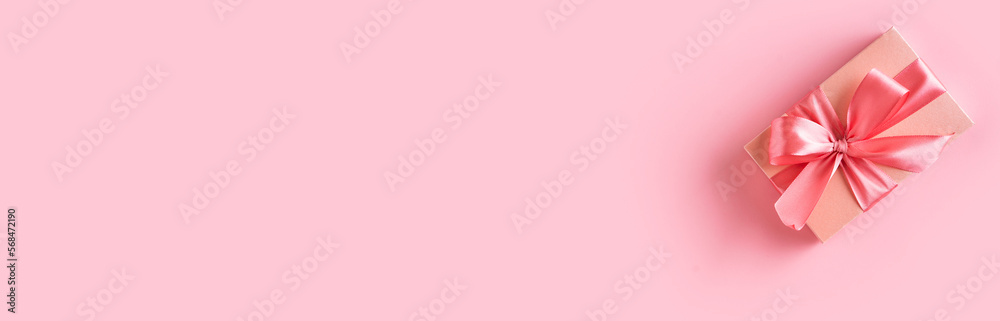 Pink gift box with bow on pink background Pink gift box with bow on pink background