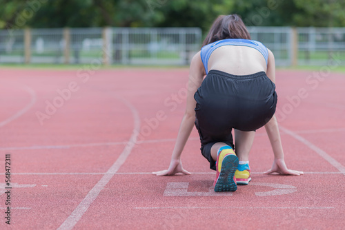 beautifull sport girl exercise at the track court and wearing blue sport bra