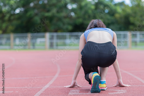 beautifull sport girl exercise at the track court and wearing blue sport bra