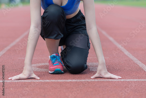 beautifull sport girl exercise at the track court and wearing blue sport bra
