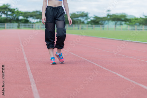 beautifull sport girl exercise at the track court and wearing blue sport bra