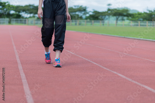 beautifull sport girl exercise at the track court and wearing blue sport bra