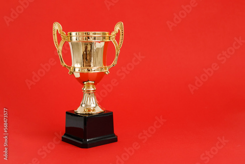 Golden Winner prize Cup on Red background.