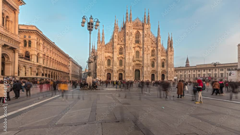 Panorama showing Milan Cathedral and Vittorio Emanuele gallery timelapse during sunset. Duomo di Milano is the cathedral church located at the Piazza del Duomo square in Milan city in Italy Panorama showing Milan Cathedral and Vittorio Emanuele gallery timelapse during sunset. Duomo di Milano is the cathedral church located at the Piazza del Duomo square in Milan city in Italy