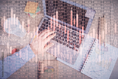 Double exposure of man's hands typing over computer keyboard and forex graph hologram drawing. Top view. Financial markets concept.