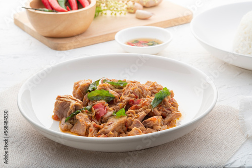 Stir Fried Canned Tuna with Thai Basil in white plate.asian spicy food