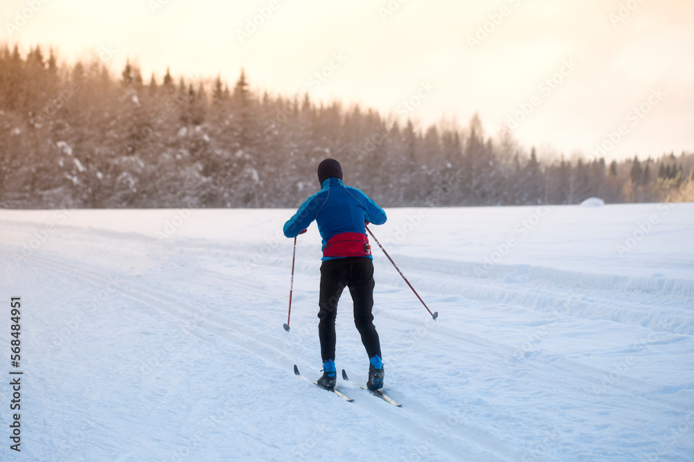 Woman cross country skiing on a sunny winter morning
