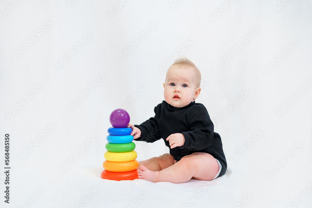 Portrait of a charming Caucasian baby in a stylish black bodysuit on a white background Portrait of a charming Caucasian baby in a stylish black bodysuit on a white background