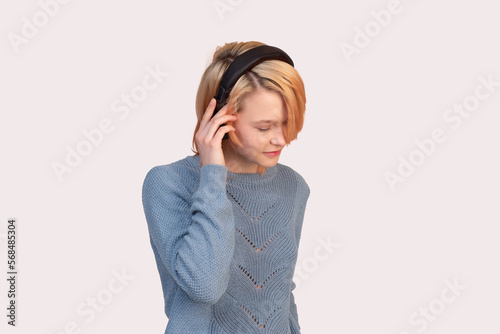 girl teenager with headphones isolated on a light background © Evgeny