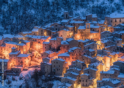 The beautiful Scanno covered in snow during a cold winter evening. Abruzzo, central Italy. photo