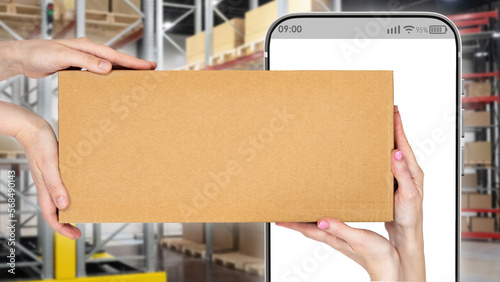 Cardboard box in hand. Phon...