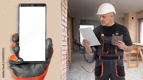 Builder at work. Phone with...