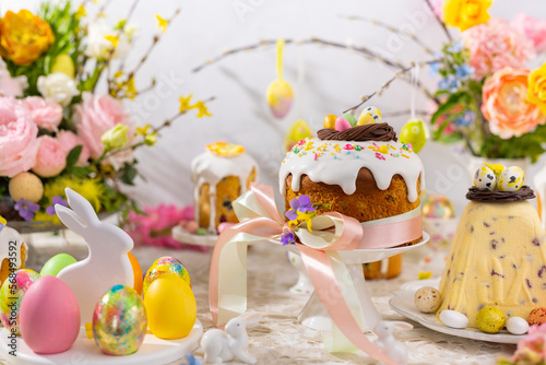 Festive Easter table setting. Easter cake, Easter Eggs, Flower arrangements and home decorations for holiday.