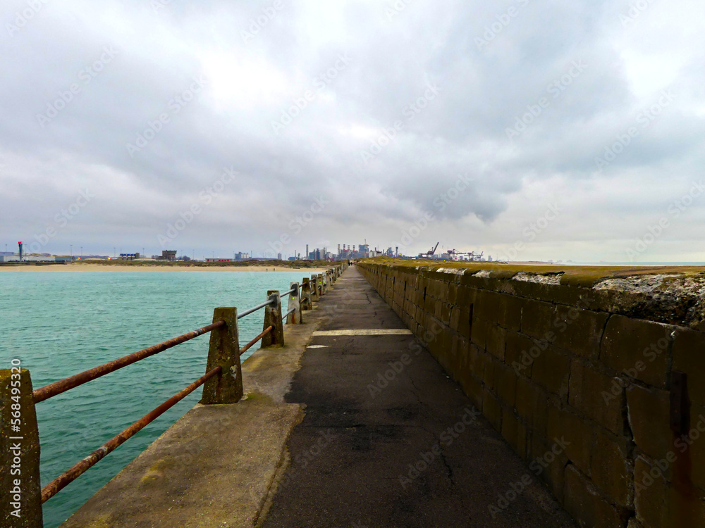 January 2023, Dunkerque - Winter walk on the Break dam - View on an industrial site	
