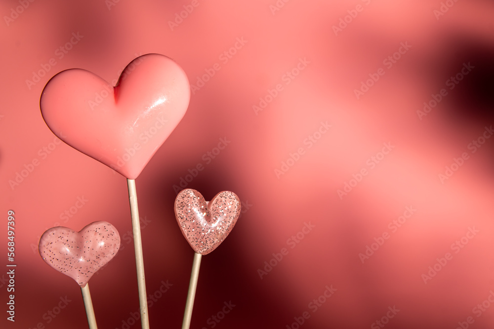 three Pink Valentine's day heart shape lollipop candy on empty pink background with different shadows. Love Concept. Minimalism colorful style. with copy space three Pink Valentine's day heart shape lollipop candy on empty pink background with different shadows. Love Concept. Minimalism colorful style. with copy space