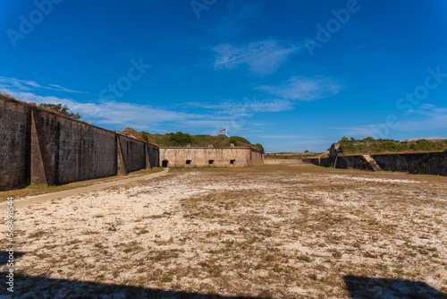 Gulf Islands National Seashore along Gulf of Mexico barrier islands of Florida. Fort Pickens pentagonal historic United States military fort on Santa Rosa Island. Counter scarp dry moat and flag. 