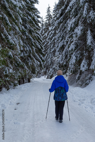 Snowy winter landscape in Slovakia. Hiker woman on mountain trail photo