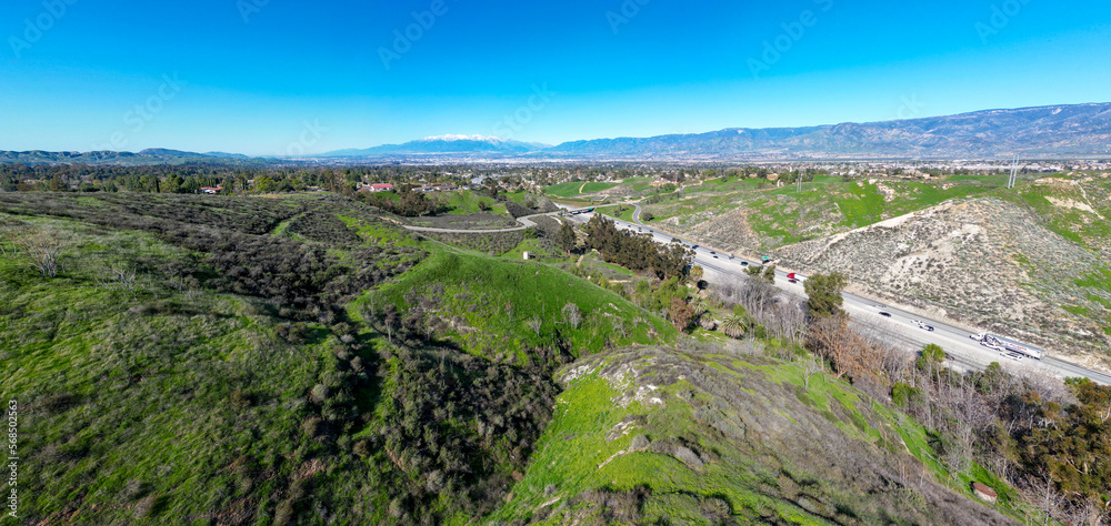 A UAV Aerial view of the I-10 Freeway to Redlands and Yucaipa, California, through Reservoir Canyon with the San Bernardino Mountain Capped with Snow