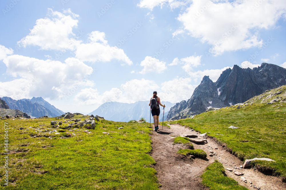 Fototapeta premium Young hiker girl summit to Ratera Peak in Aiguestortes and Sant Maurici National Park, Spain