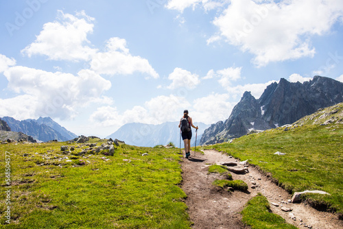 Young hiker girl summit to Ratera Peak in Aiguestortes and Sant Maurici National Park, Spain