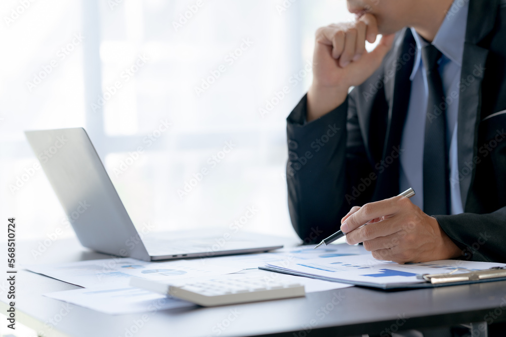 Business man pointing to expense chart image for the allocation of the company's next year's revenue budget in the office. Business man pointing to expense chart image for the allocation of the company's next year's revenue budget in the office.