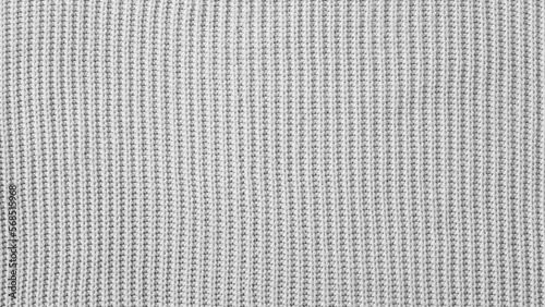 Grey texture of a knitted woolen fabric. Black and white craft Background