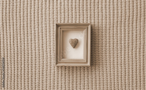 Vintage Valentines Day background with cookie heart in a wooden frame and knitted background. Sepia style