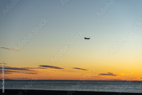 Airplane landing at sunrise over Mediterranean Sea, Costa del Sol, Malaga, Spain © Vitali
