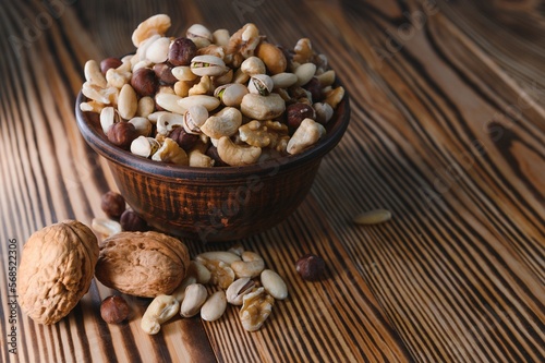 Mixed nuts on wood floor. Organic and fresh nuts. Copy space