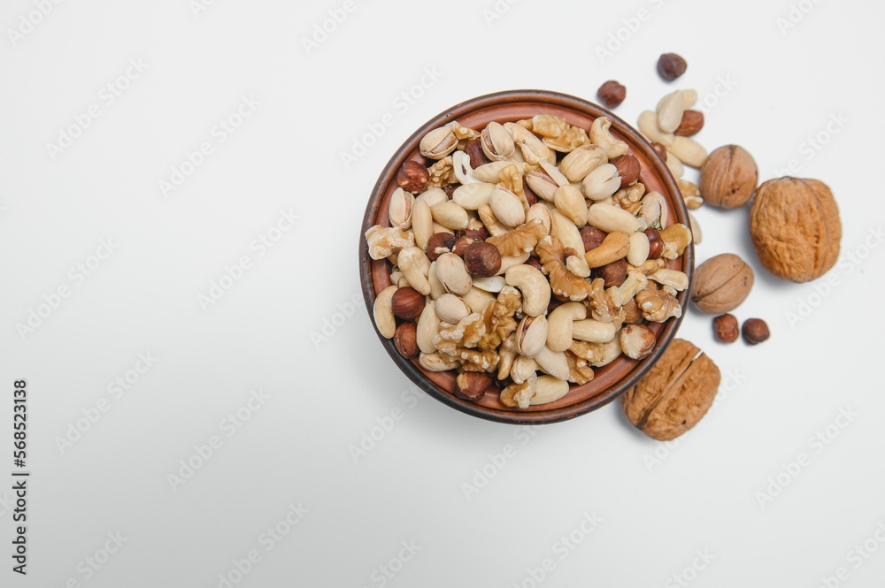 Mixed nuts on a plate. White background Mixed nuts on a plate. White background