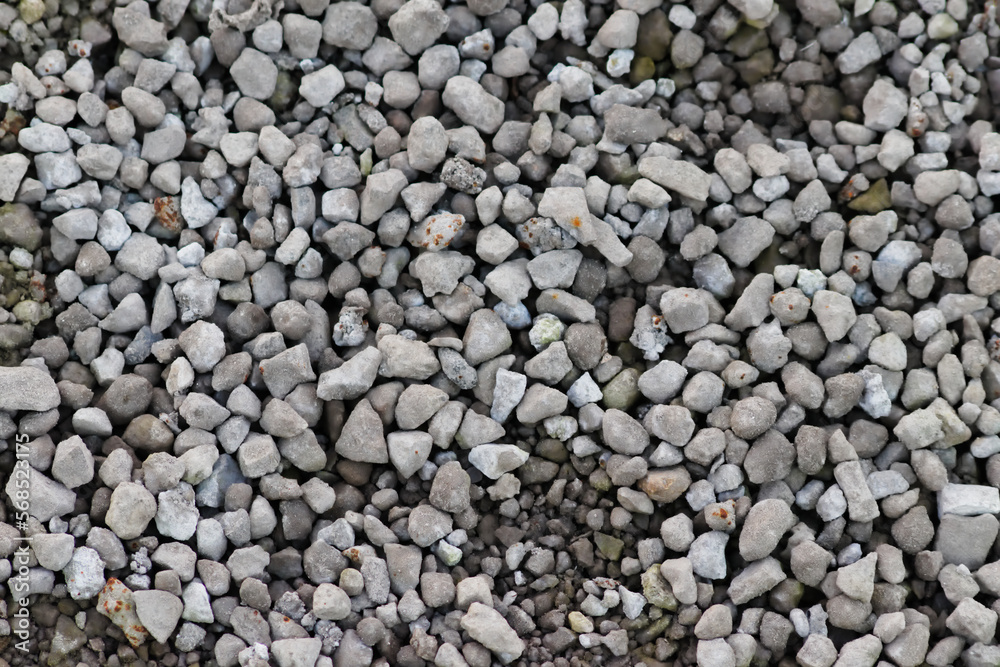 Gray raw rocks and rough stones as natural stones background with crushed and rough material as building material or rocky base for concrete mixture in gray colors as natural stones background Gray raw rocks and rough stones as natural stones background with crushed and rough material as building material or rocky base for concrete mixture in gray colors as natural stones background