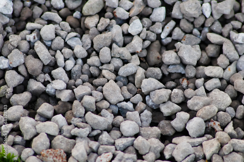 Gray raw rocks and rough stones as natural stones background with crushed and rough material as building material or rocky base for concrete mixture in gray colors as natural stones background Gray raw rocks and rough stones as natural stones background with crushed and rough material as building material or rocky base for concrete mixture in gray colors as natural stones background