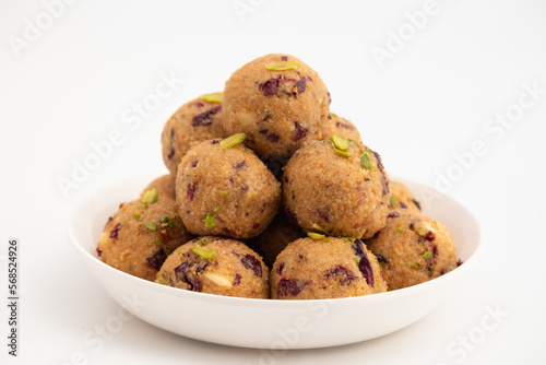 Indian Mithai Gulab Churma Ke Laddu Or Choorma Ke Ladoo Is Made Of Whole Wheat Jada Gehun Ka Atta, Khus Khus, Gur, Jaggery, Kaju, Badam, Edible Rose Petals, Dry Fruits In Desi Ghee Or Clarified Butter