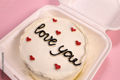 Trendy bento cake delicate biscuit with the inscription love you close-up