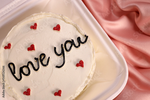 Trendy bento cake delicate biscuit with the inscription I love you close-up