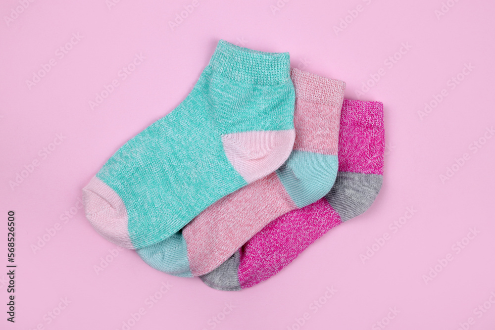 Stack of baby socks on pink background Stack of baby socks on pink background