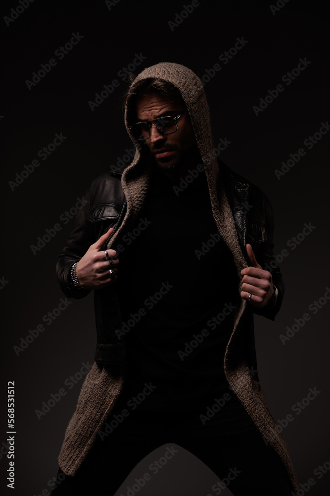 mysterious cool guy adjusting and pulling leather jacket and wool cardigan mysterious cool guy adjusting and pulling leather jacket and wool cardigan