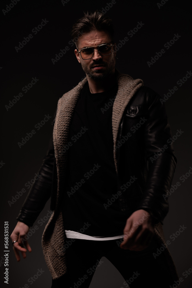 fashion stylish guy with cool hairstyle wearing wool cardigan and leather jacket