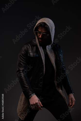 sexy bearded man with glasses looking to side and confidently posing