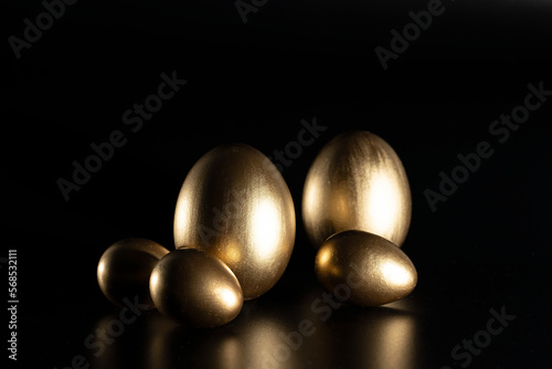 Easter, Gold birds eggs shot against a dark background 