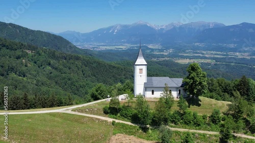 Aerial morning view of St. Primoz church at Jamnik, Slovenia, Julian alps. photo