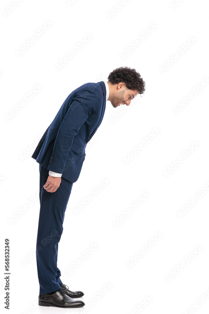 elegant young businessman looking down at something small on the floor elegant young businessman looking down at something small on the floor