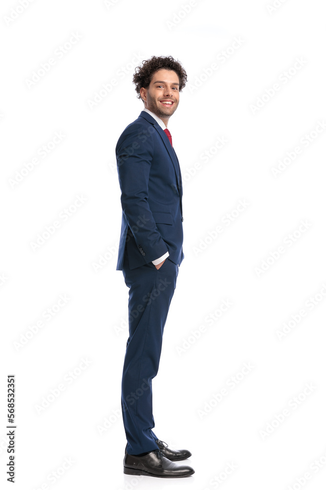 side view of happy elegant businessman smiling and posing with hands in pockets side view of happy elegant businessman smiling and posing with hands in pockets